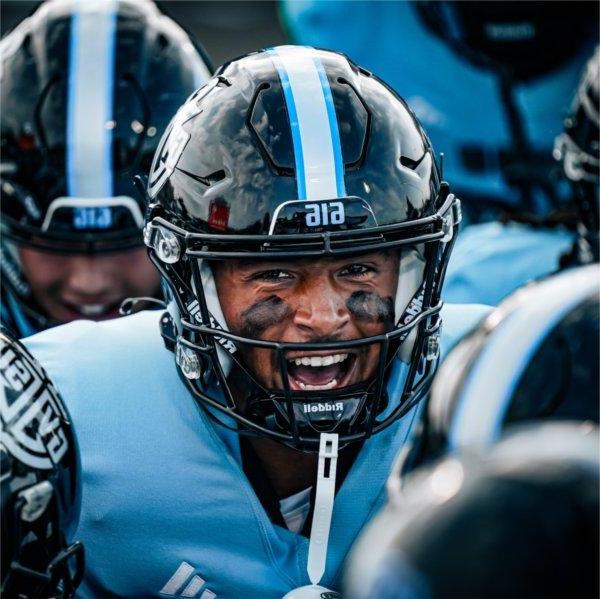 A Lakers football player fires up his teammates before the start of a game.