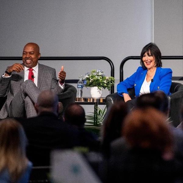 Grand Valley President Philomena V. Mantella and Ferris State President Bill Pink share a laugh on stage during a panel discussion.